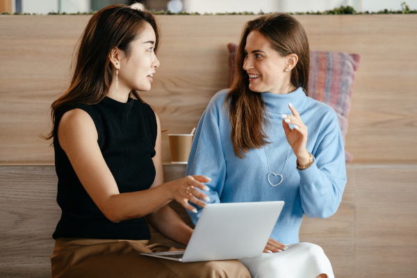 Two women with laptop and a look of surprise